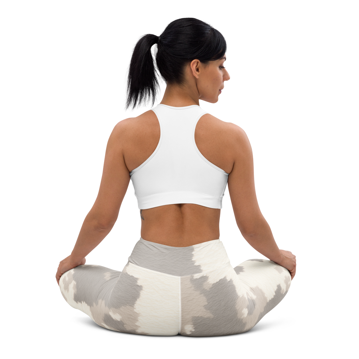 Caspra Beige camouflage high-waisted yoga leggings, seated back view.