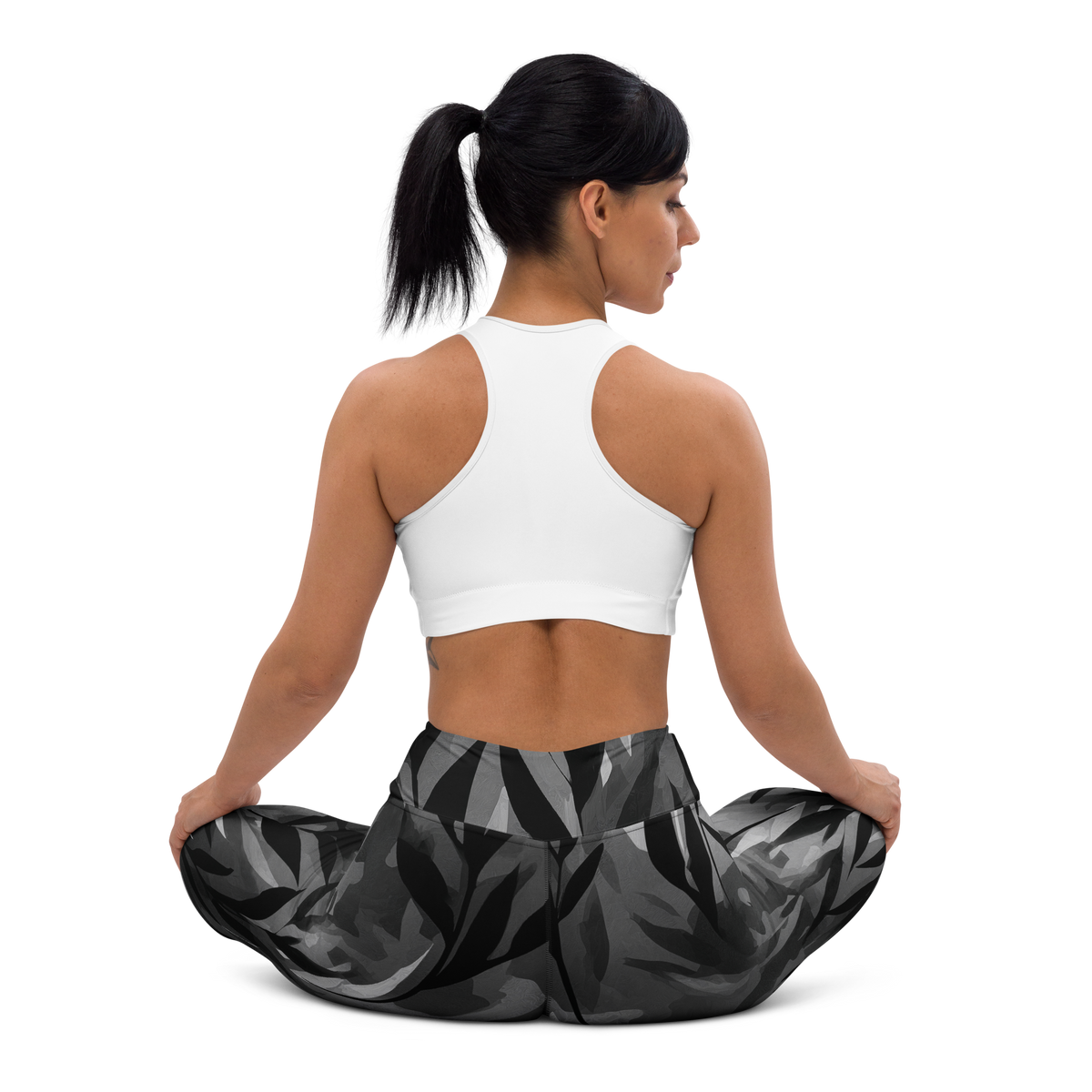 Gardenia Greyscale high-waisted yoga leggings, seated back view.