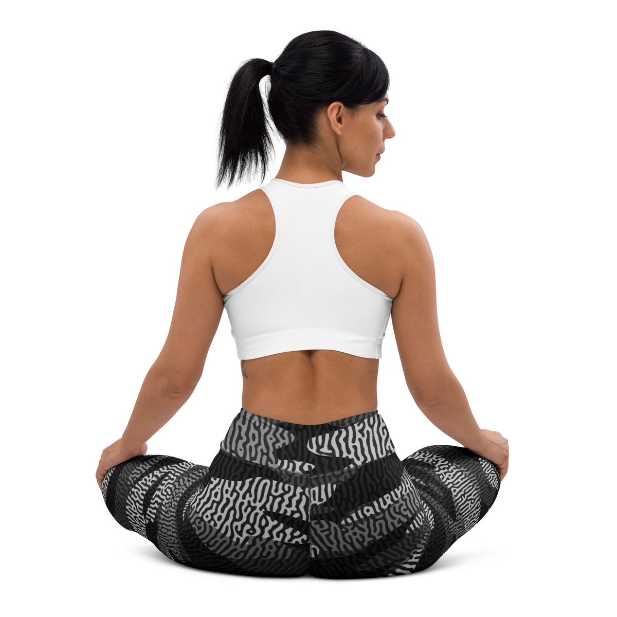 Gulf Turing Greyscale camouflage high-waisted yoga leggings, seated back view.