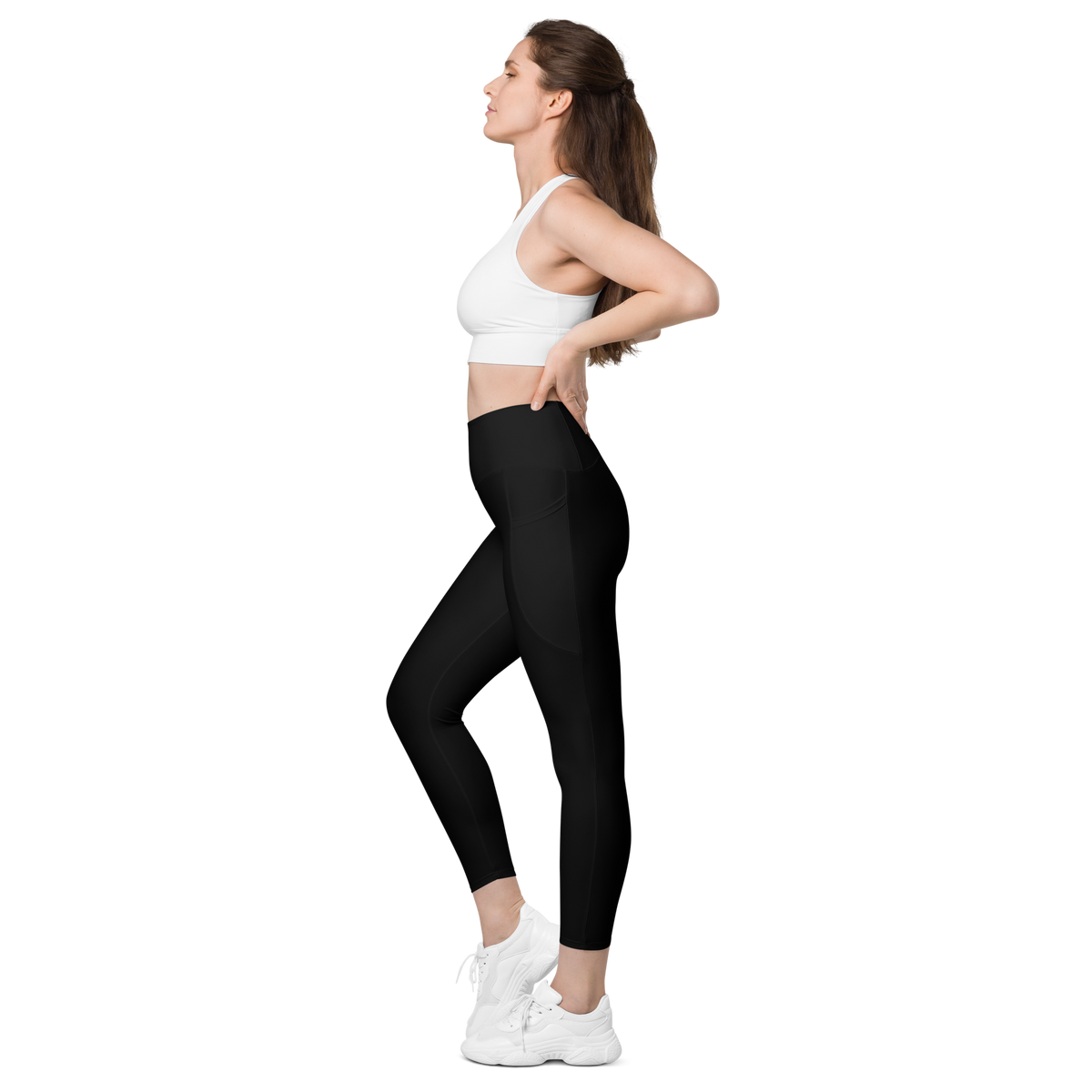 Plain Black high-waisted pocket leggings, pocket-in-use view.