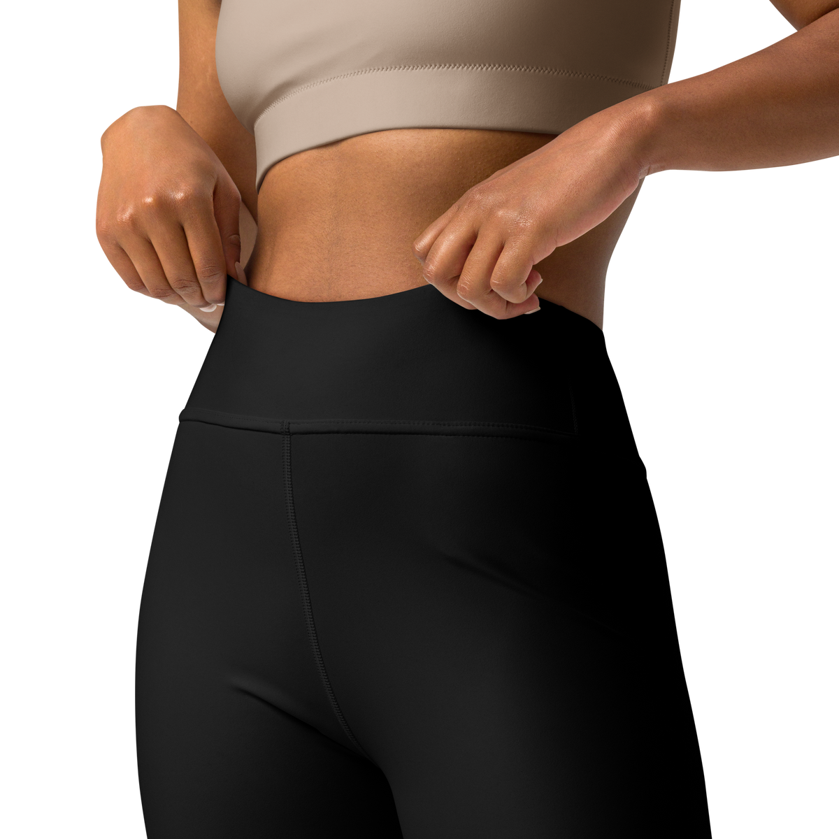 Plain Black high-waisted yoga leggings, waistband and construction detail.