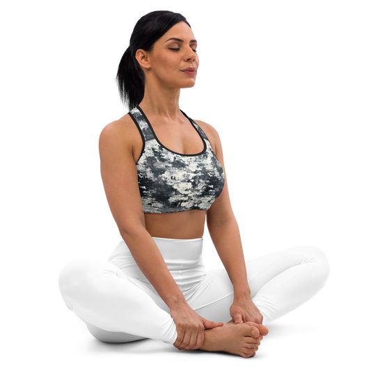 Seated front view of the Textra Greyscale medium-support padded sports bra with woven grid