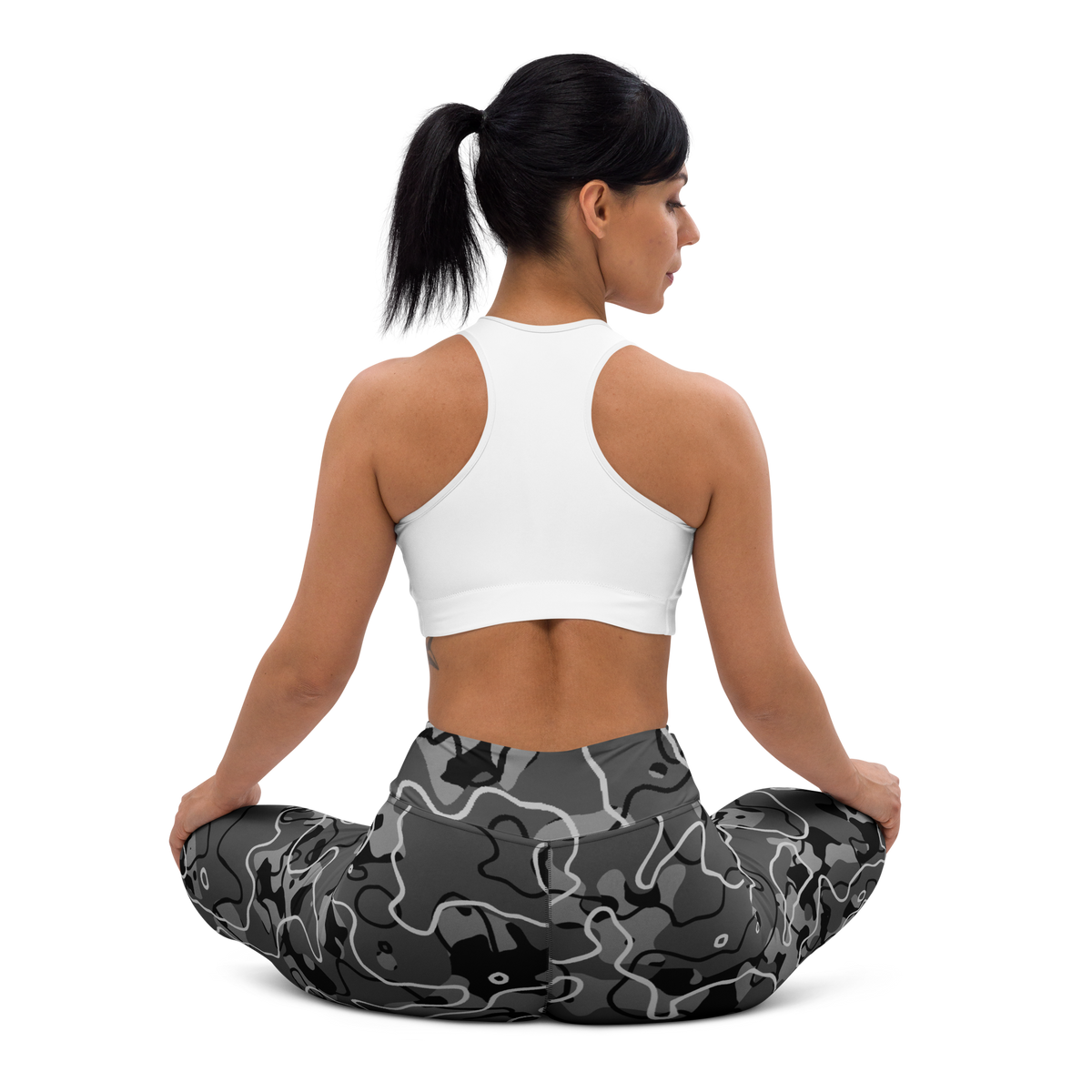 Tundra Greyscale camouflage high-waisted yoga leggings, seated back view.
